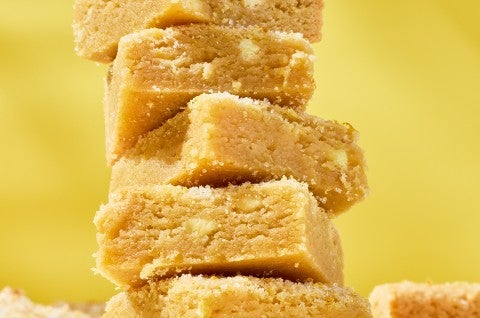 Detailed photograph of Alex Roberts Lemon Citrus Blondies stacked. - select to zoom