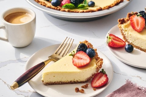 Easy Cheesecake sliced and on a plate with a cup of coffee - select to zoom