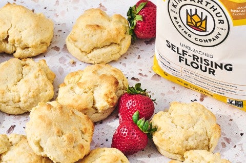 Easy Drop Biscuits on a counter with strawberries and self-rising flour - select to zoom