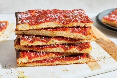 Side photo of a stack of Rhode Island Pizza Strip slices.