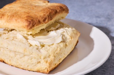Small-Batch Biscuit served on a plate with butter - select to zoom