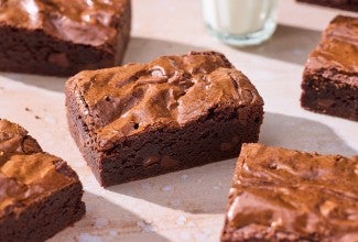 Small-Batch Brownies on a table with a glass of milk