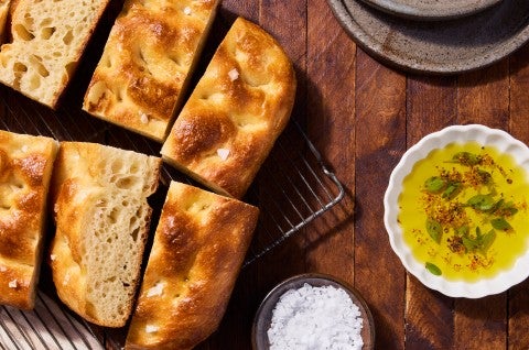 Sourdough Focaccia on a cooling rack with olive oil and salt